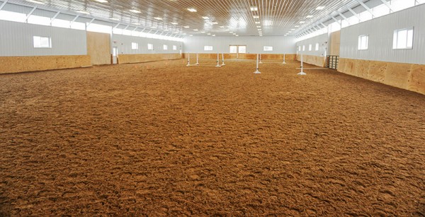 Consistent Footing, Ride After Ride Equine riding arena with uniform footing over Paddock Slab base, designed to improve surface consistency, reduce fatigue, and support horse movement during training.