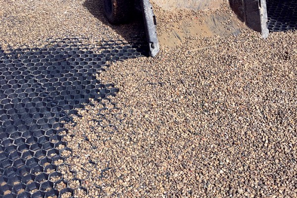 Pea Gravel Infill for Livestock Drainage and Hoof Support Demonstration of Paddock Slab tiles being filled with pea gravel, showing how the system locks together to create a stable, well-drained livestock surface.